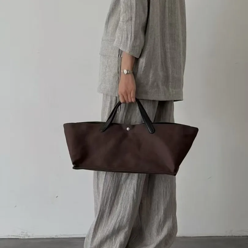 

Canvas spliced ​​cowhide women's tote bag 2025 new niche design large capacity simple crossbody bag fashionable handbag