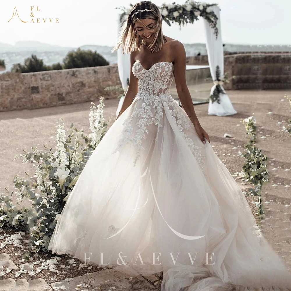 

Breathtaking Strapless Wedding Dress Featuring Stunning Crystals Lace Appliques and Flowy A-Line Silhouette Bridal Dress