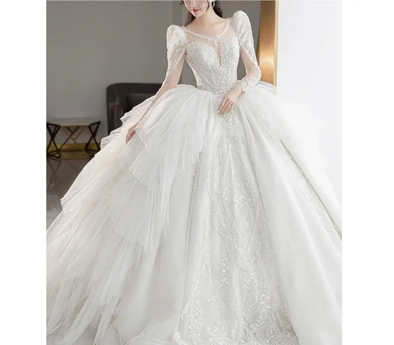

HA 87 New style bridal gown with long sleeves and tail