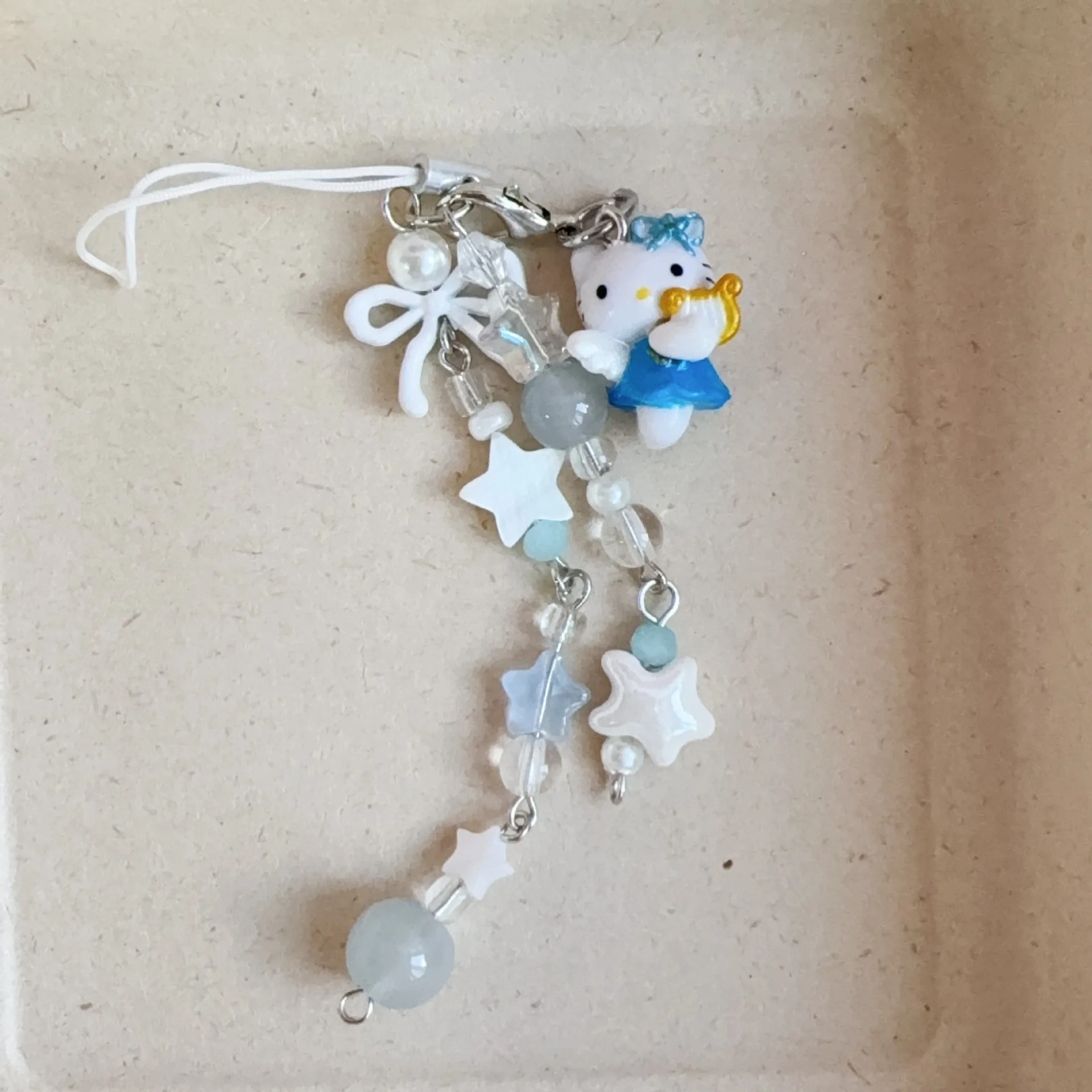 ซานริโอ เฮลโล คิตตี้ ลิตเติ้ล ดอลฟิน หนังสีดำ สายคล้องโทรศัพท์แบบทำมือประดับลูกปัด สายคล้องกระเป๋า สายคล้องกล้อง ของขวัญวันเกิดสำหรับเด็กผู้หญิง