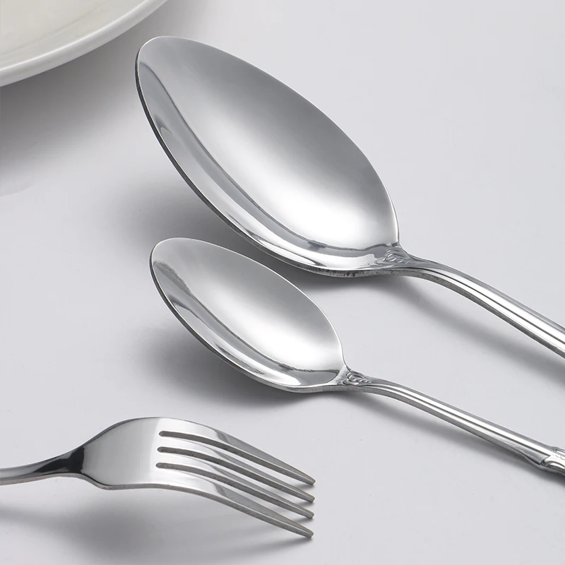 40pcs Elegant Silver Cutlery Set Features Stainless Steel Openwork Handles and Includes Forks, Spoons, and Knives. Perfect for W