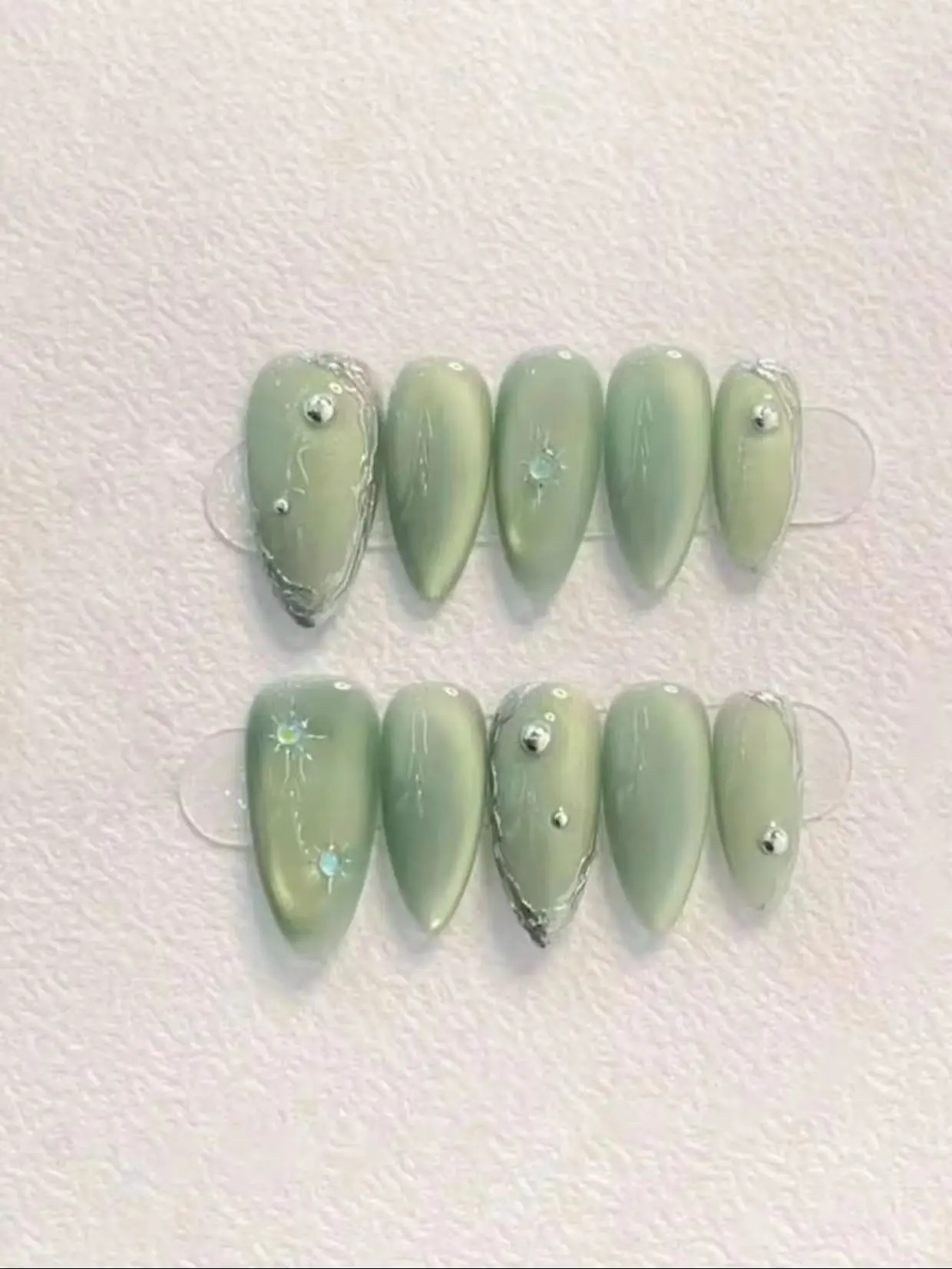 10 Pieces of Medium-Pointed Almond-Shaped Cat-Eye Press-On Nails, Cool Forest Style Ins-Style Fake Nails, with Silver Foil Fragments, Star-Shaped Rhinestones, and Metal Beads Decoration, Glossy and Reusable, Suitable for Spring and Summer Outings, Commuting, and Dates, Niche Handmade Nail Art in Green Grape Ice Color