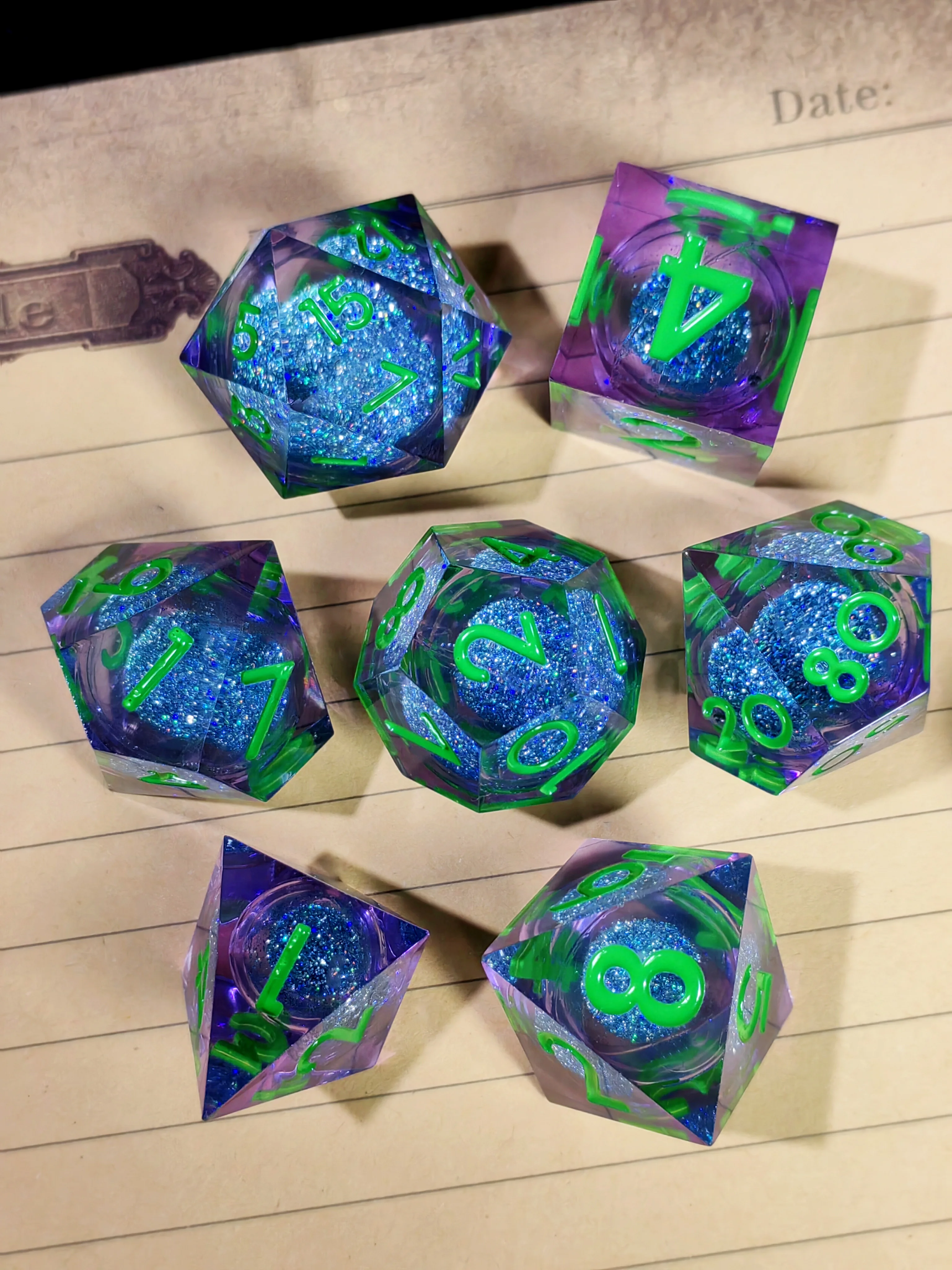DnD Dice Set – 7 Piece Sharp Edge Resin Dice, Blue Sand, Transparent Base, Green Numbers, for Dungeons & Dragons, RPG