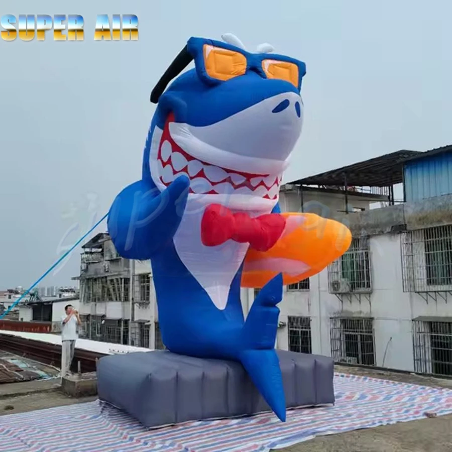 Hermoso modelo de organismo marino, sonrisa, tiburón inflable, sostiene el tobogán y observación de gafas de sol a la venta