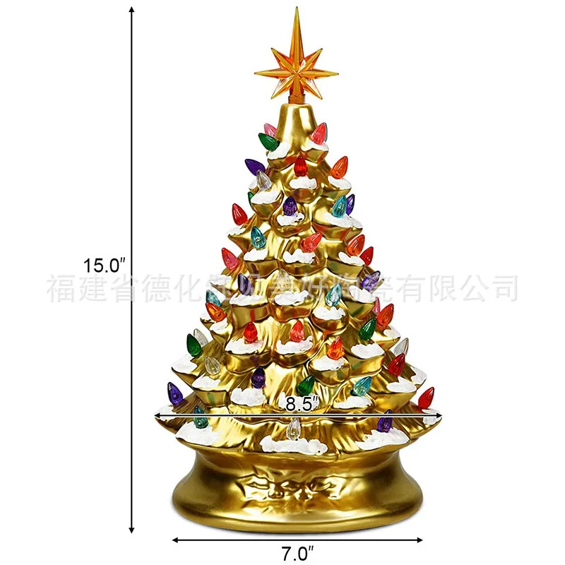 Golden and silver resin Christmas tree with snowflakes and glowing colored lights- a festive table