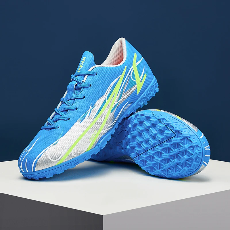 أحذية كرة القدم المهنية الرجال في الهواء الطلق عالية الجودة أحذية كرة القدم الرياضية الأحذية Ag/Fg المسامير الطويلة العشب الاصطناعي التدريب مباراة Spi #1