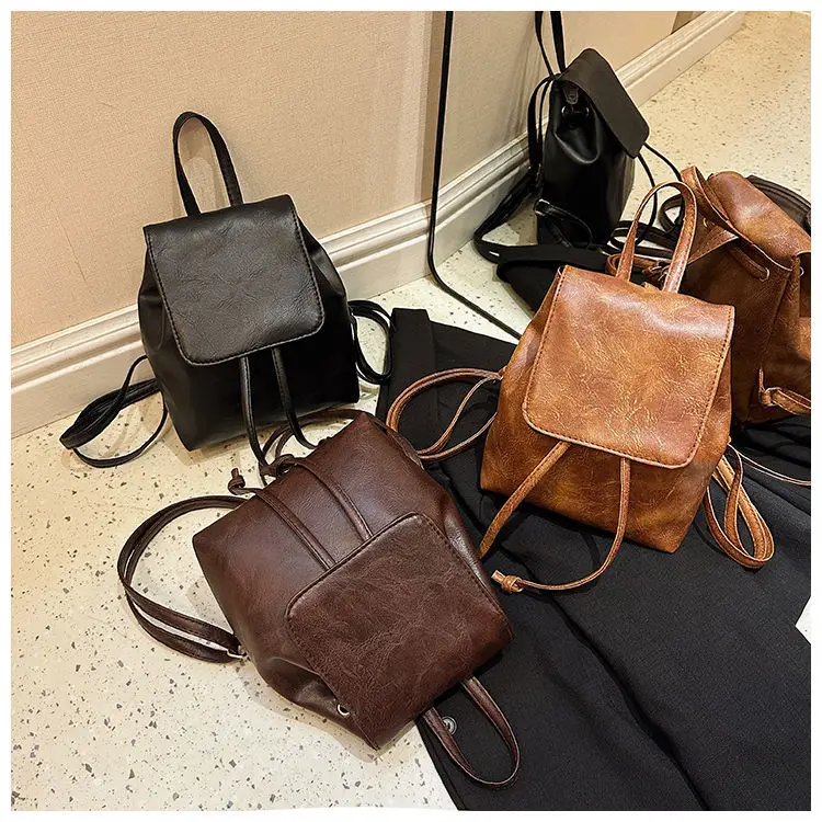 กระเป๋าถือสุภาพสตรีสีทึบวินเทจสาววิทยาลัยกระเป๋าเป้สะพายหลังหนัง Pu ขนาดกะทัดรัดน้ำหนักเบาเชือกกระเป๋าสะพายลำลองสำหรับผู้หญิง