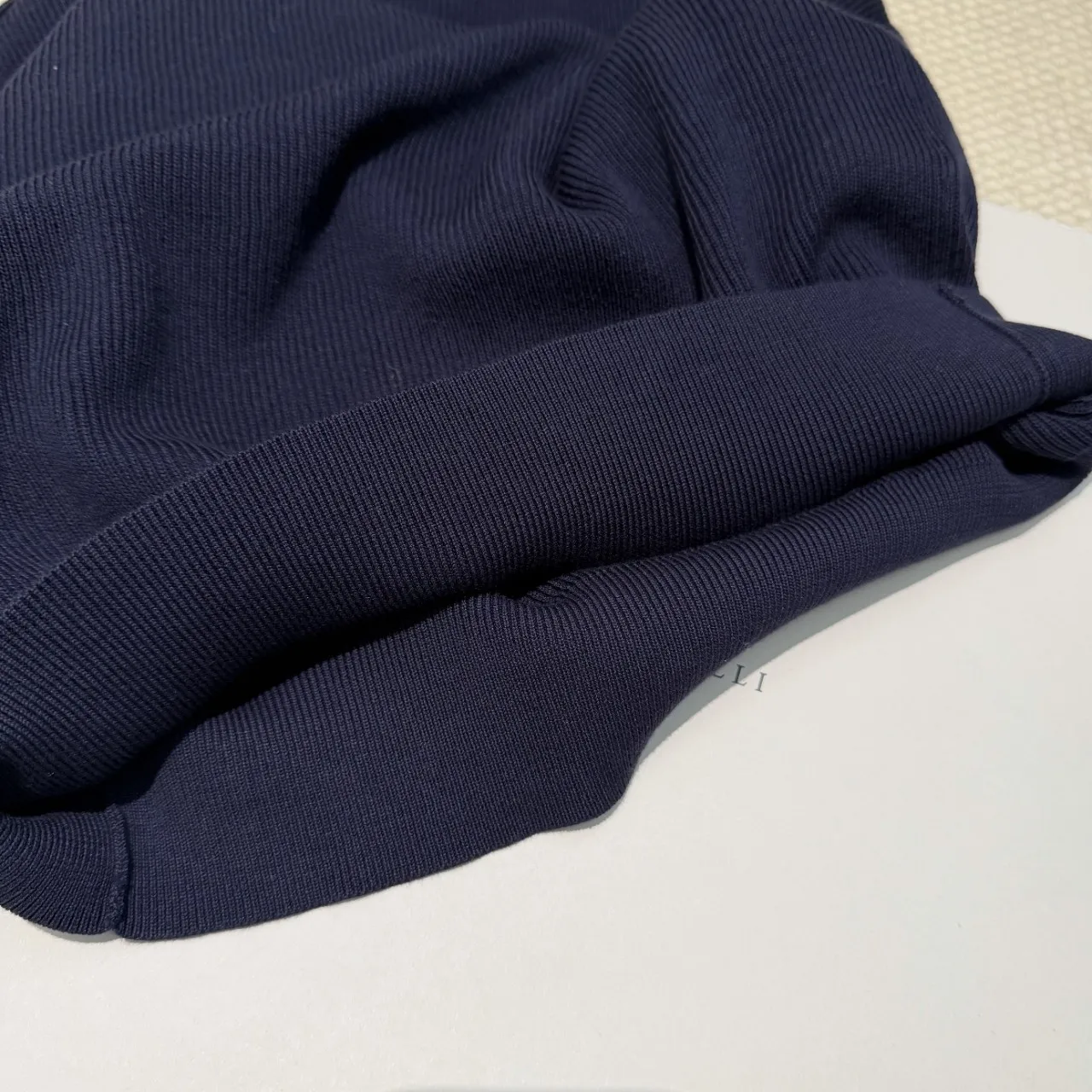 Men's old money style knit short sleeve polo shirt with minimalist v-neck and contrast color cuff detail