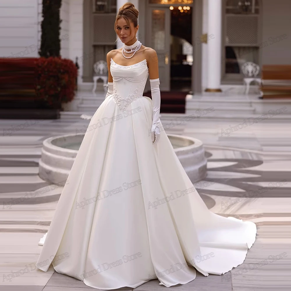 ชุดแต่งงานที่งดงาม ชุดเจ้าสาวที่มีเสน่ห์ ประดับด้วยลูกปัด แอพพลิเคชั่น คอเรือ เสื้อคลุมแขนกุด วินเทจ เวสติโด เด โนเวีย แบบสั่งตัด