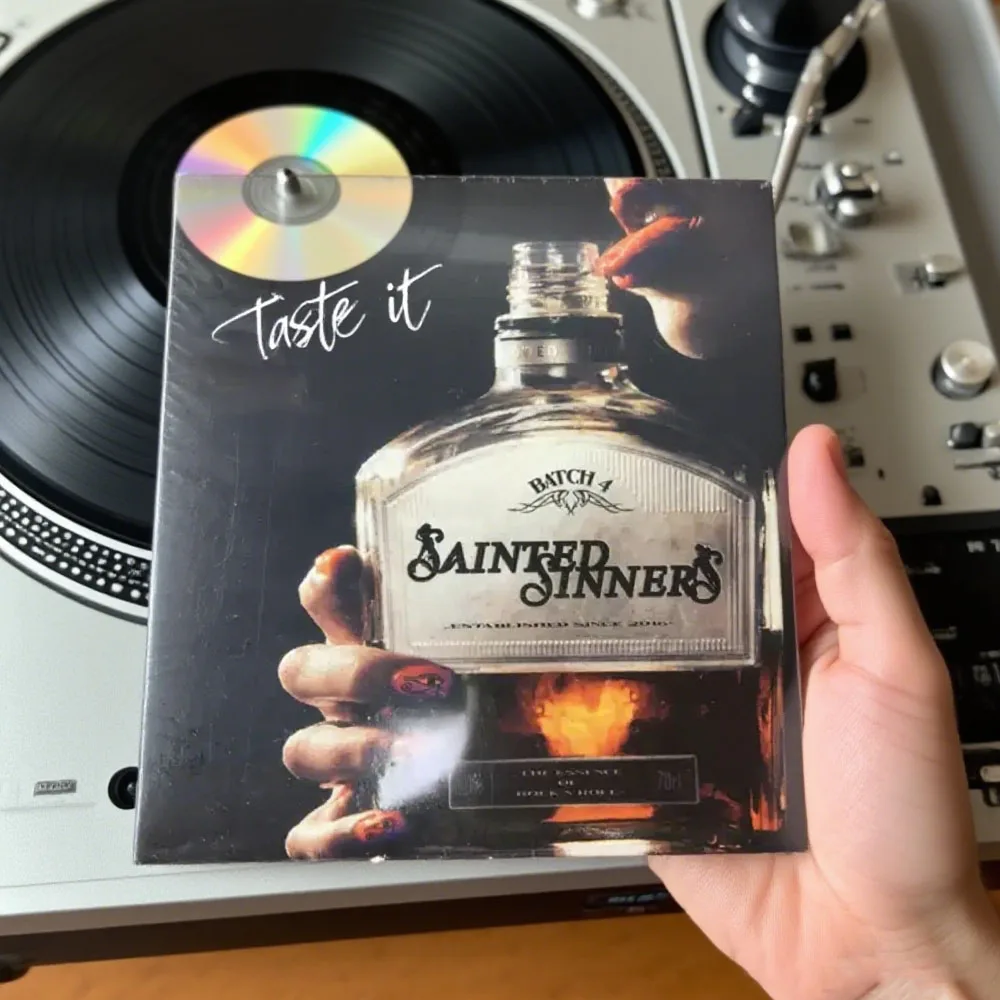 CDSainted Sinners Taste It: Hard Rock Base + Blues Guitar Riff, Prelude Scratching Ears, Lead Singer's Voice Is Rough and Tense