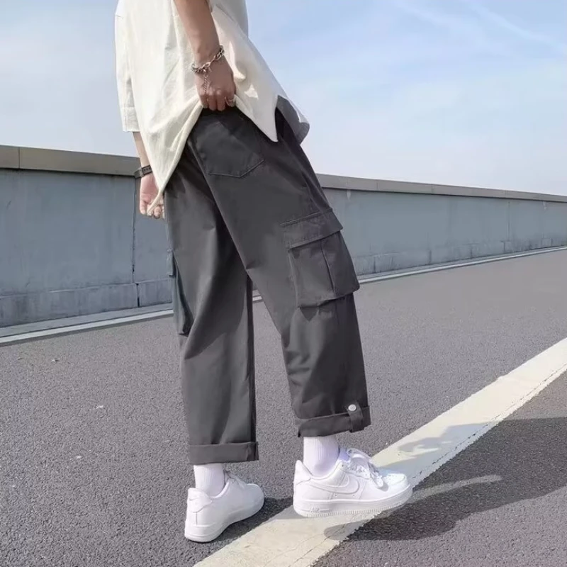 Pantaloni cargo da uomo in puro colore funzionale Techwear stile giapponese alla caviglia larghi per adolescenti popolare e accogliente design semplice con bottoni