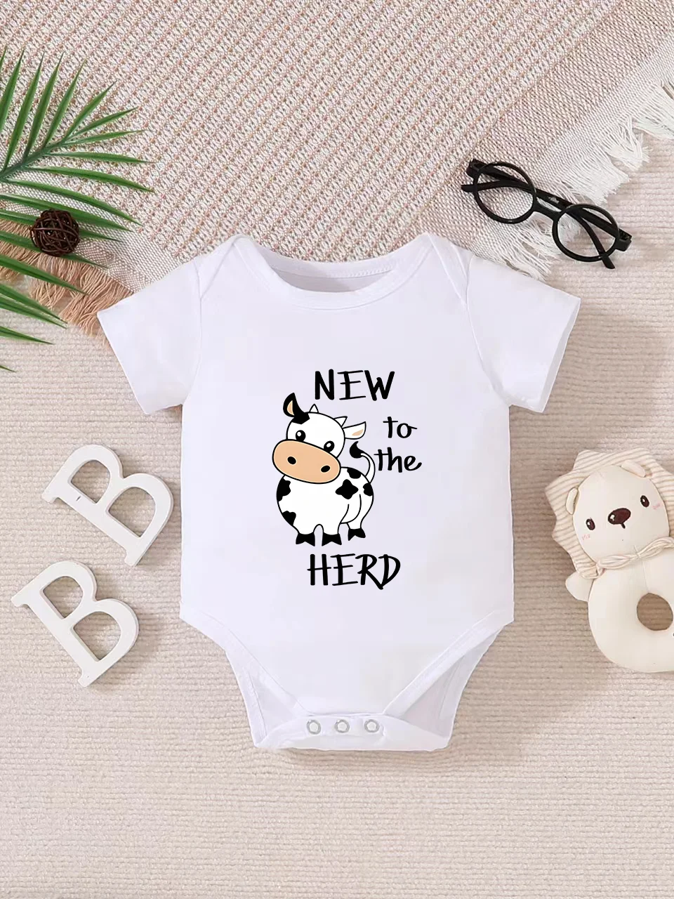 Playful letter-printed baby short-sleeve triangle bodysuit. Button closure for easy dressing