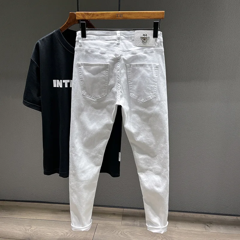 White jeans men's ripped fashion design street casual Pu handsome stretch slim stretch casual feet trousers