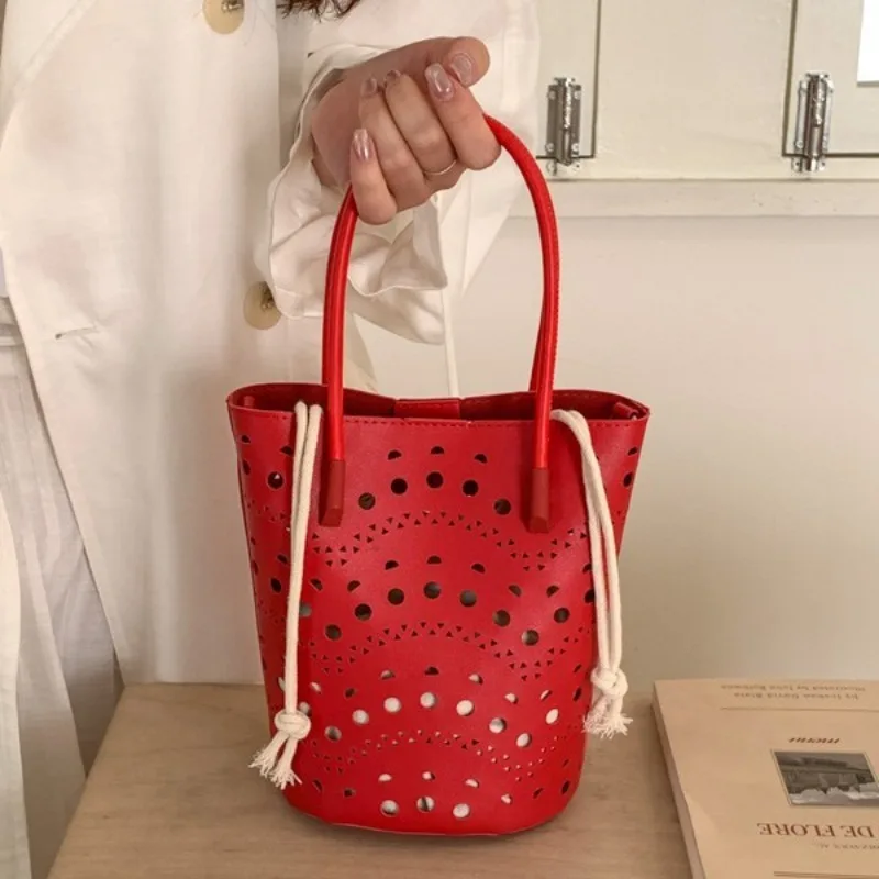 

Hollowed-out Solid Color Pu Leather Bucket Bag for Women 2026 New Fashionable and Simple Crossbody Bag Female Drawstring Handbag