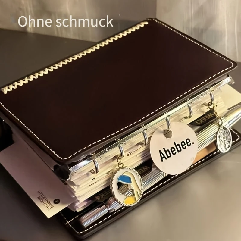 Dunkelbraunes A7-Notizbuch mit Doppelringbindung, kreatives Loseblatt-Handbuch, hochwertiges tragbares Notizbuch mit liniertem Papier, geeignet für tägliche Tagebucheinträge.