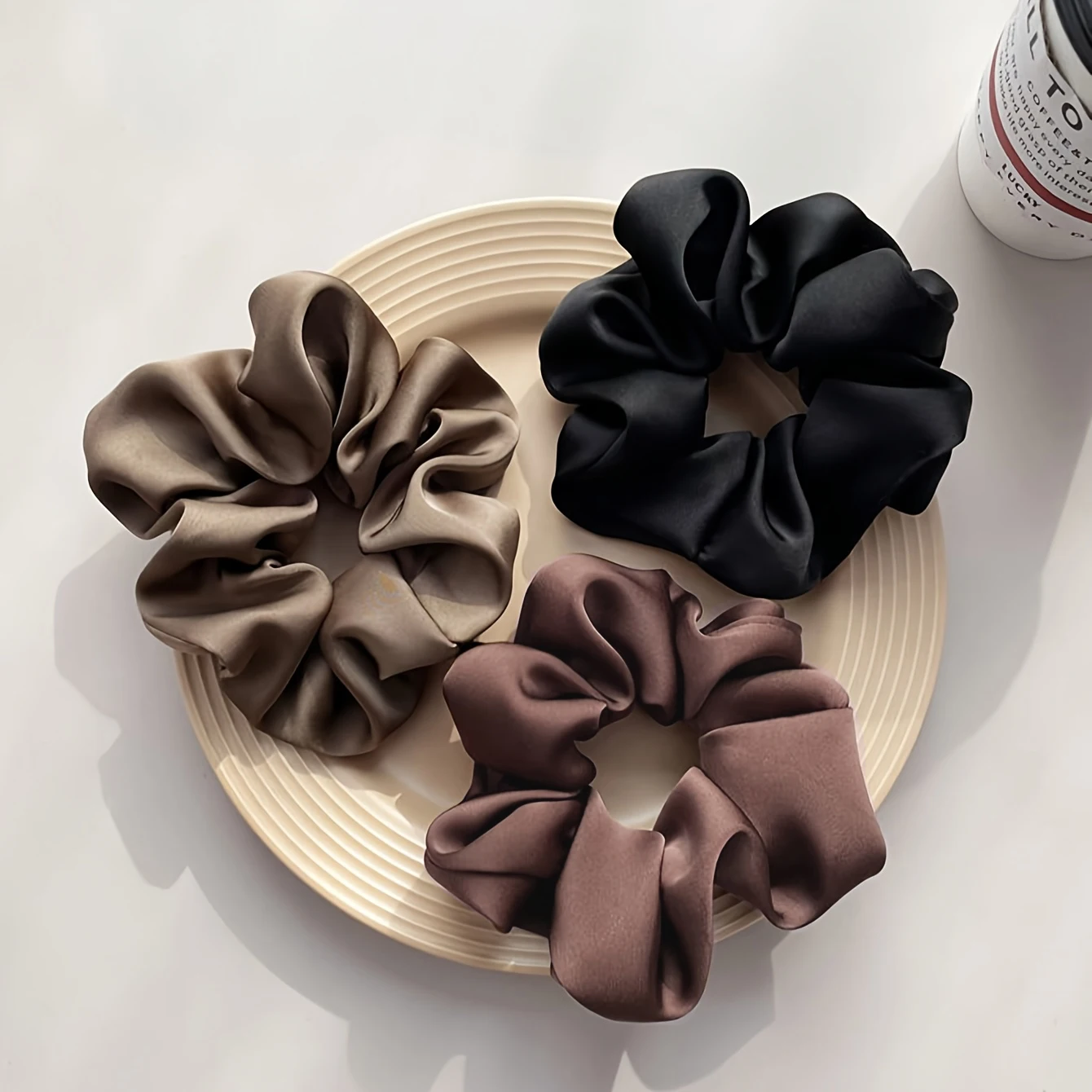 A set of three monochrome satin hair accessories, featuring an elegant and minimalist design, makes the perfect gift for holiday