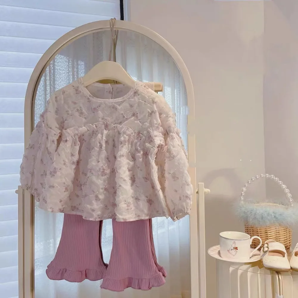 

Girls' set of stylish autumn outfits for babies, including a puff-sleeve floral top and a lace-trimmed pair of trousers