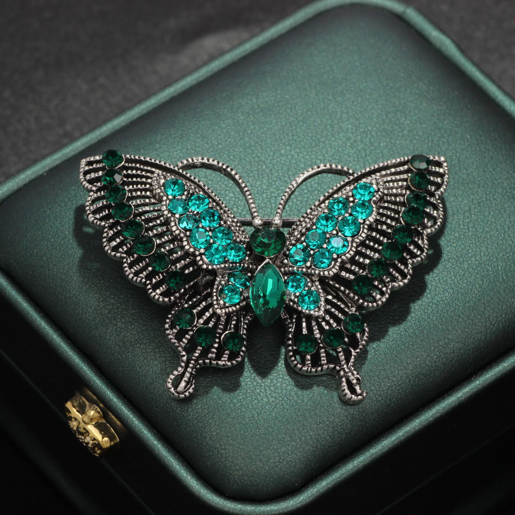 

Glamorous Vintage Silver Tone Filigree Green Crystal Butterfly Brooch