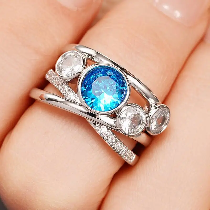 خاتم نسائي فضي اللون من Huitan مرصع بالزركون الأزرق المتلألئ وإكسسوارات ساحرة عصرية مجوهرات أنيقة للحفلات اليومية #1