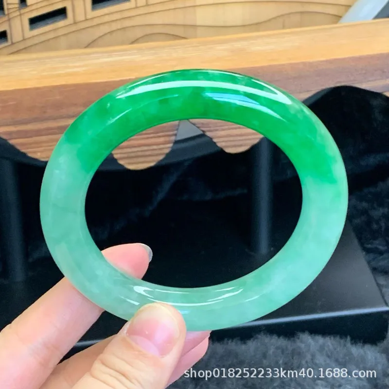 A natural large-sized Burmese bracelet a single piece of jade with an icy smooth texture and a vibrant bright green co