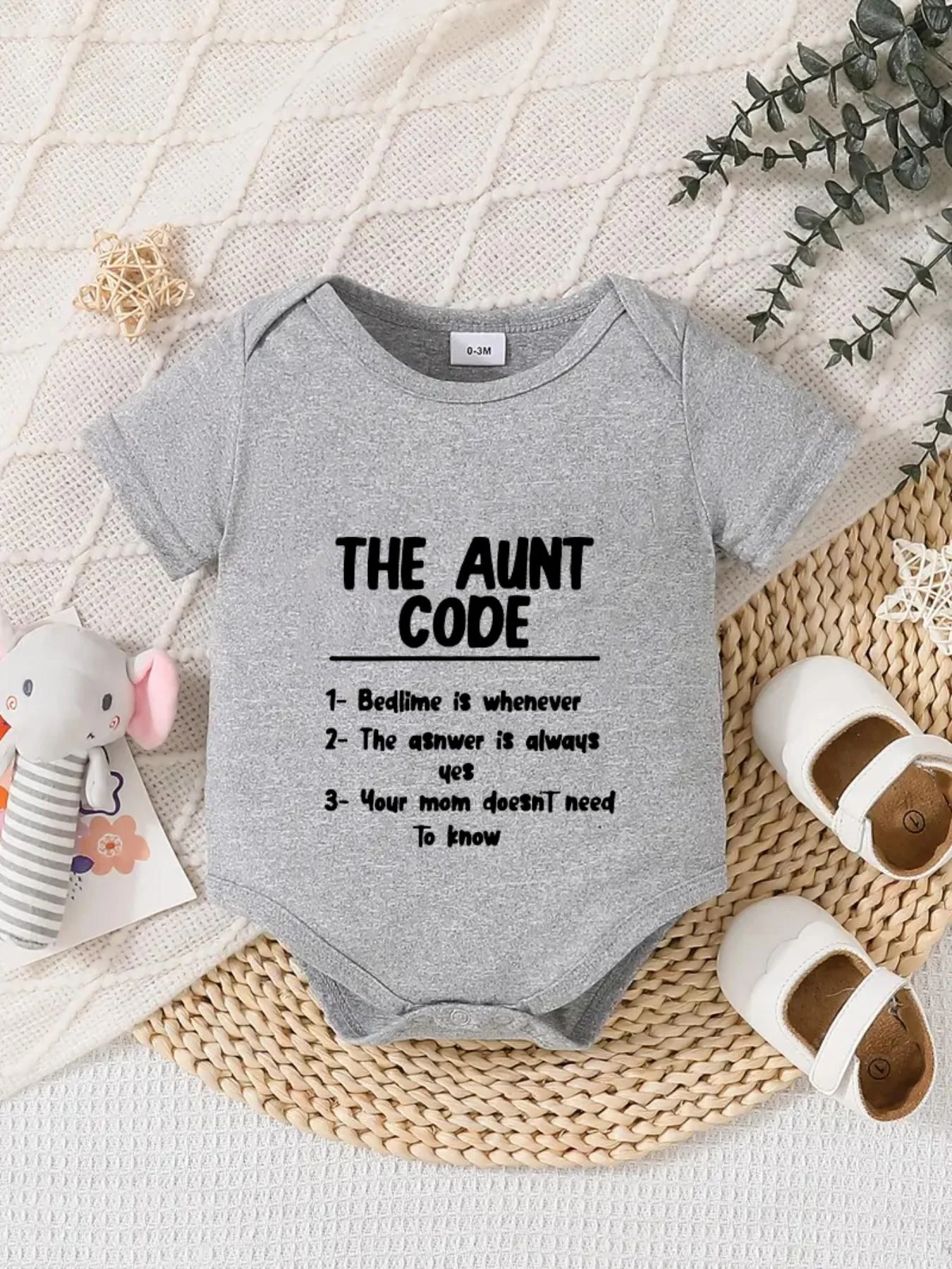 Playful letter-printed baby short-sleeve triangle bodysuit. Button closure for easy dressing, machine washable