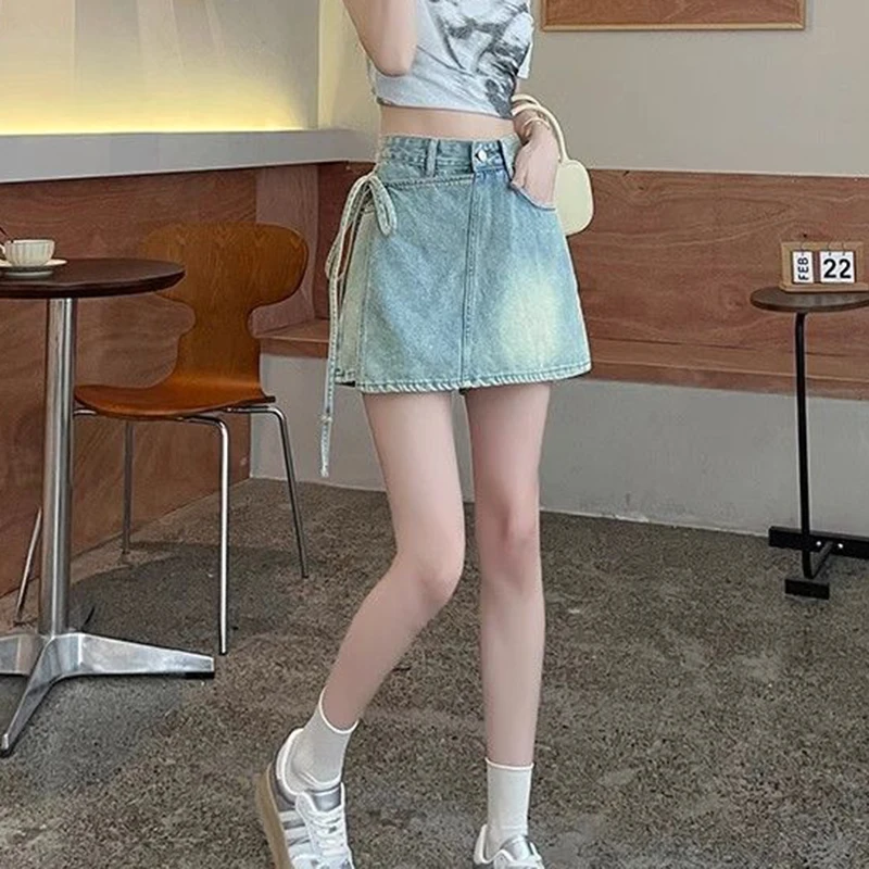 Fake two pieces of denim shorts women\'s summer new A-shaped high waist irregular western-style strap skirt slim Joker hot pants.