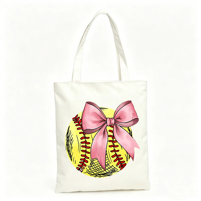Women's canvas tote bag with softball and bow graphic, ideal for casual outings and sports events