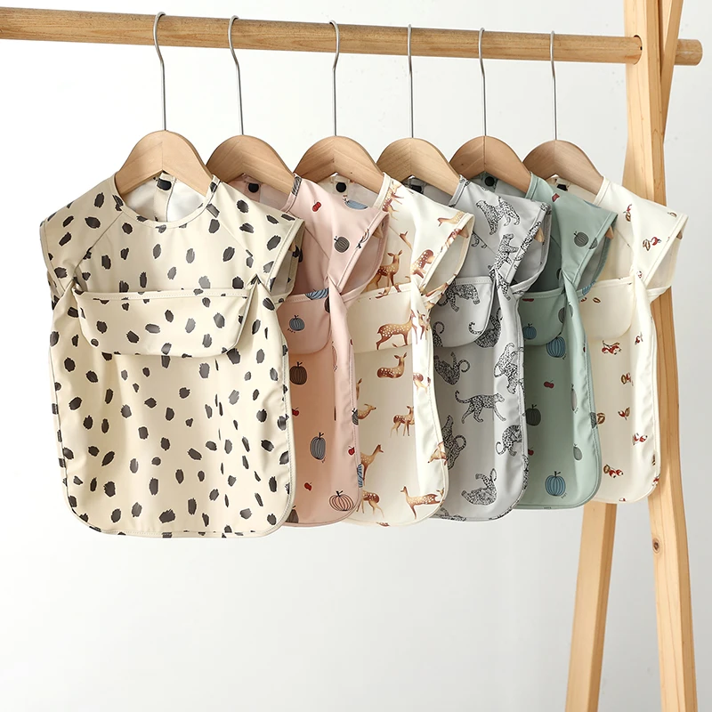 

Детские нагрудники без рукавов, водонепроницаемый фартук из искусственной кожи с принтом, нагрудник для новорожденных, Слюнявчики из ткани, Детские принадлежности, милая художественная накидка для кормления ребенка