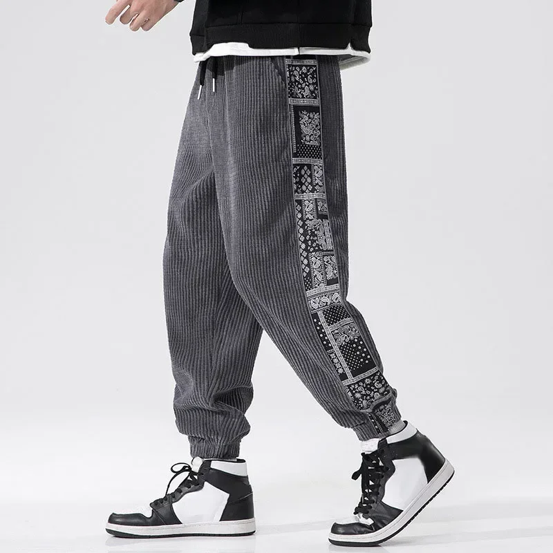 Pantalones de pana con cintura elástica para hombre, ropa de calle Harajuku, chándal informal, pantalones de retazos estampados, moda de otoño e invierno