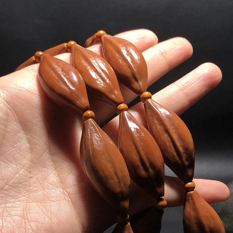 carving, slender leaf-shaped , 1.7mm old oil , long string hanging as a necklace, olive core pendan