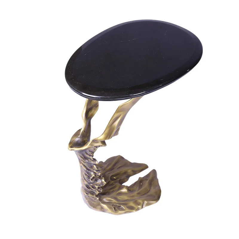 

Living room sofa next to water ripple edge transparent resin small round coffee table marble copper corner table