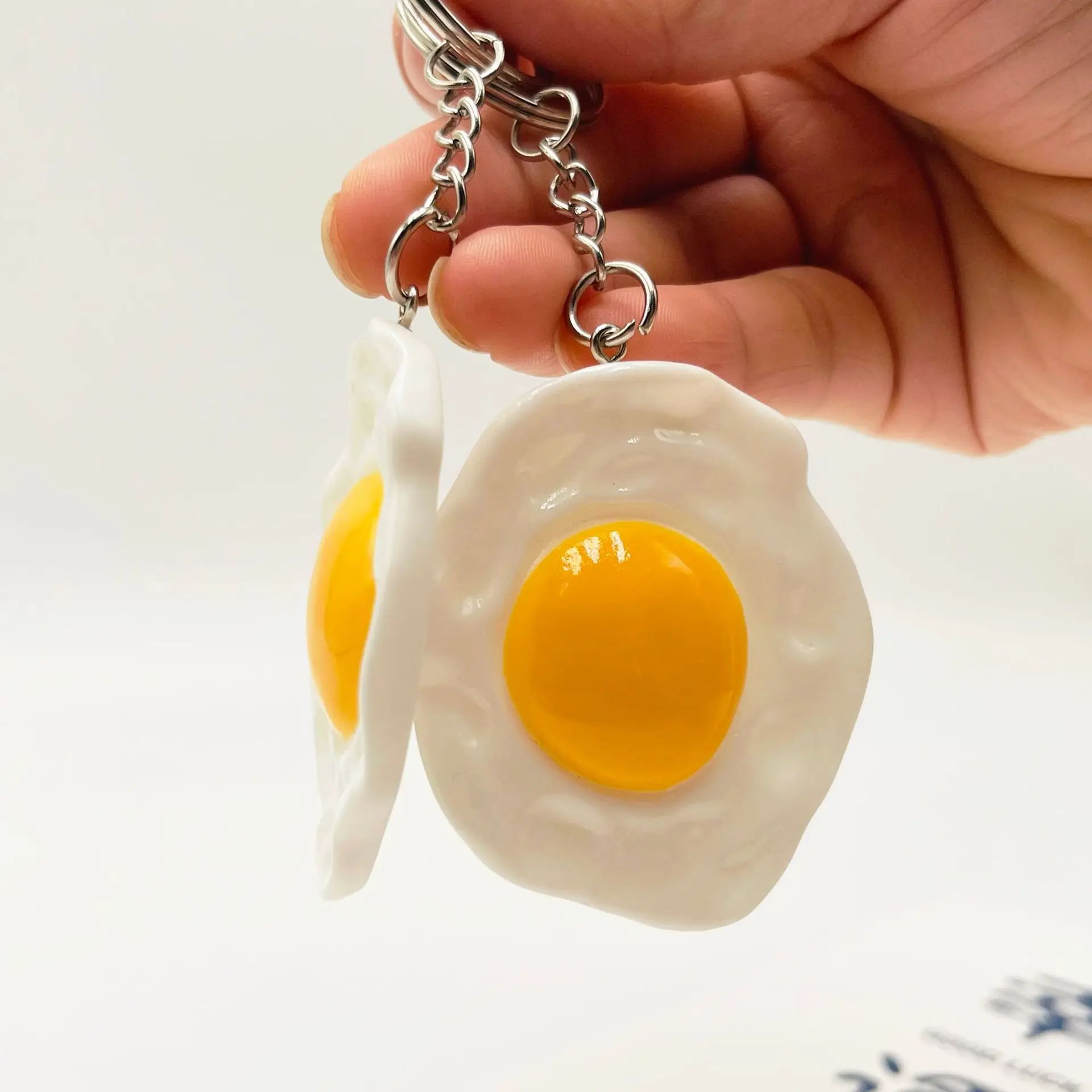 One. New resin egg key chain bag pendant, poached egg pendant promotional gifts spot wholesale. Color random.