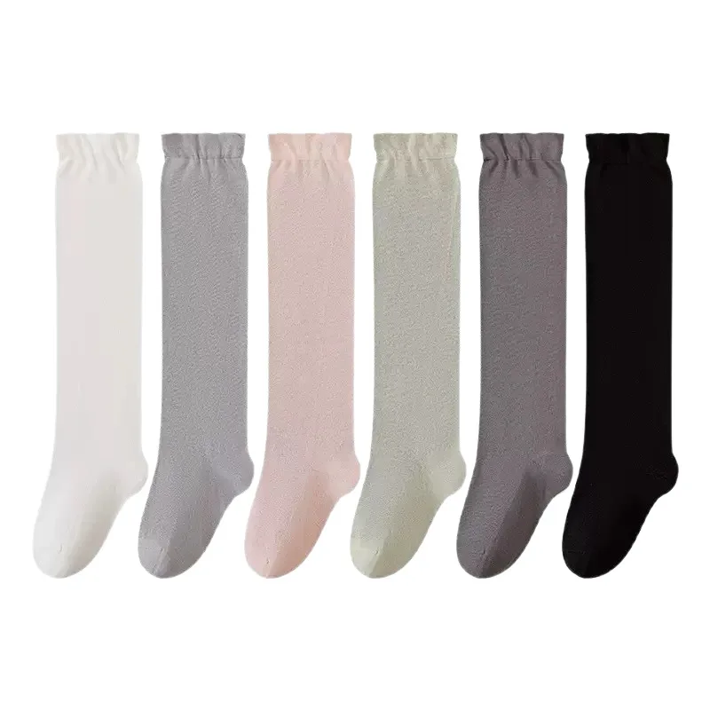 A pair of autumn and winter new solid color sweet women's warm knee high socks with wide elastic mouth, slimming long stockings