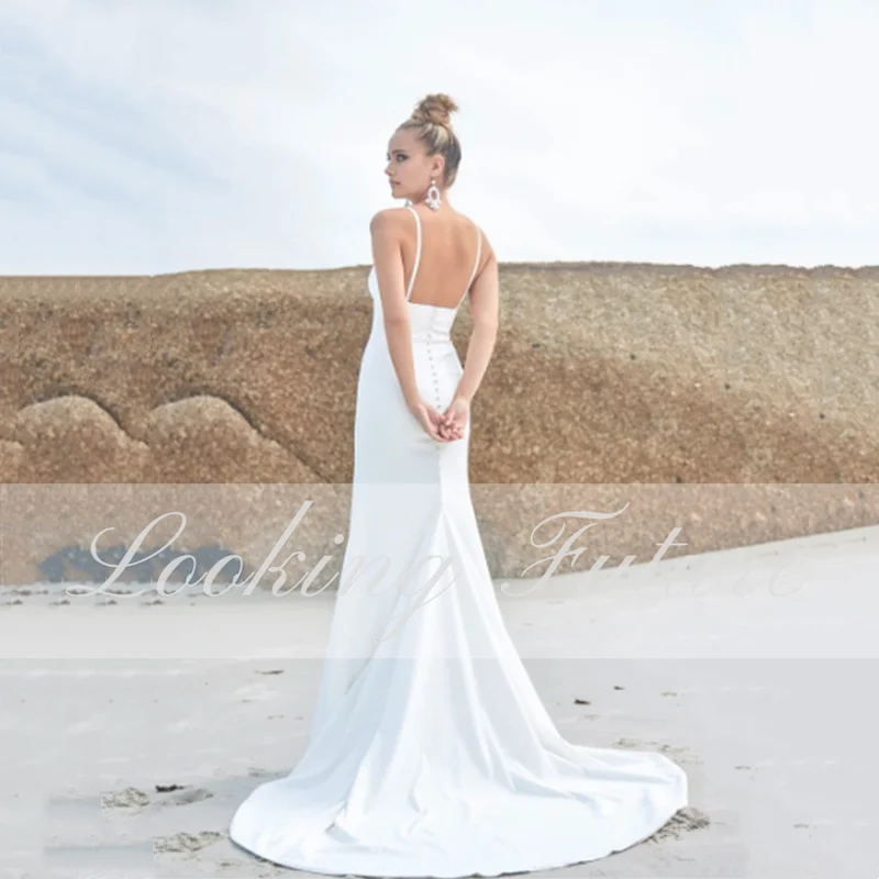 Abiti da sposa a sirena bianca da spiaggia cinturino per Spaghetti senza maniche abito da sposa senza spalline Sexy senza schienale con bottone Robe De Mariee