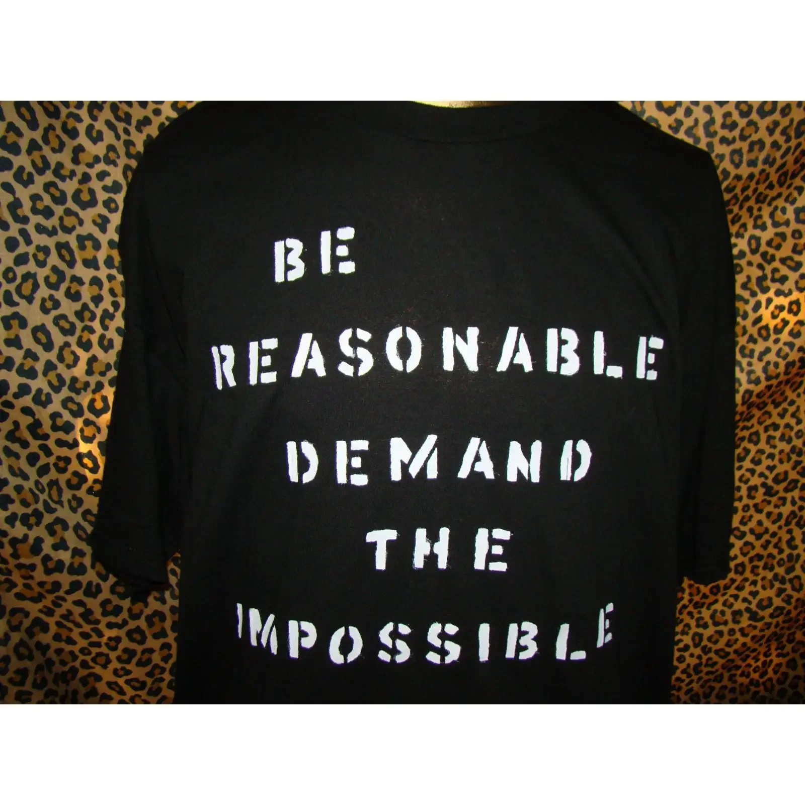 May include Black t shirt with white text that reads Be Reasonable Demand The Impossible vintage Washed Stylish Soft homme