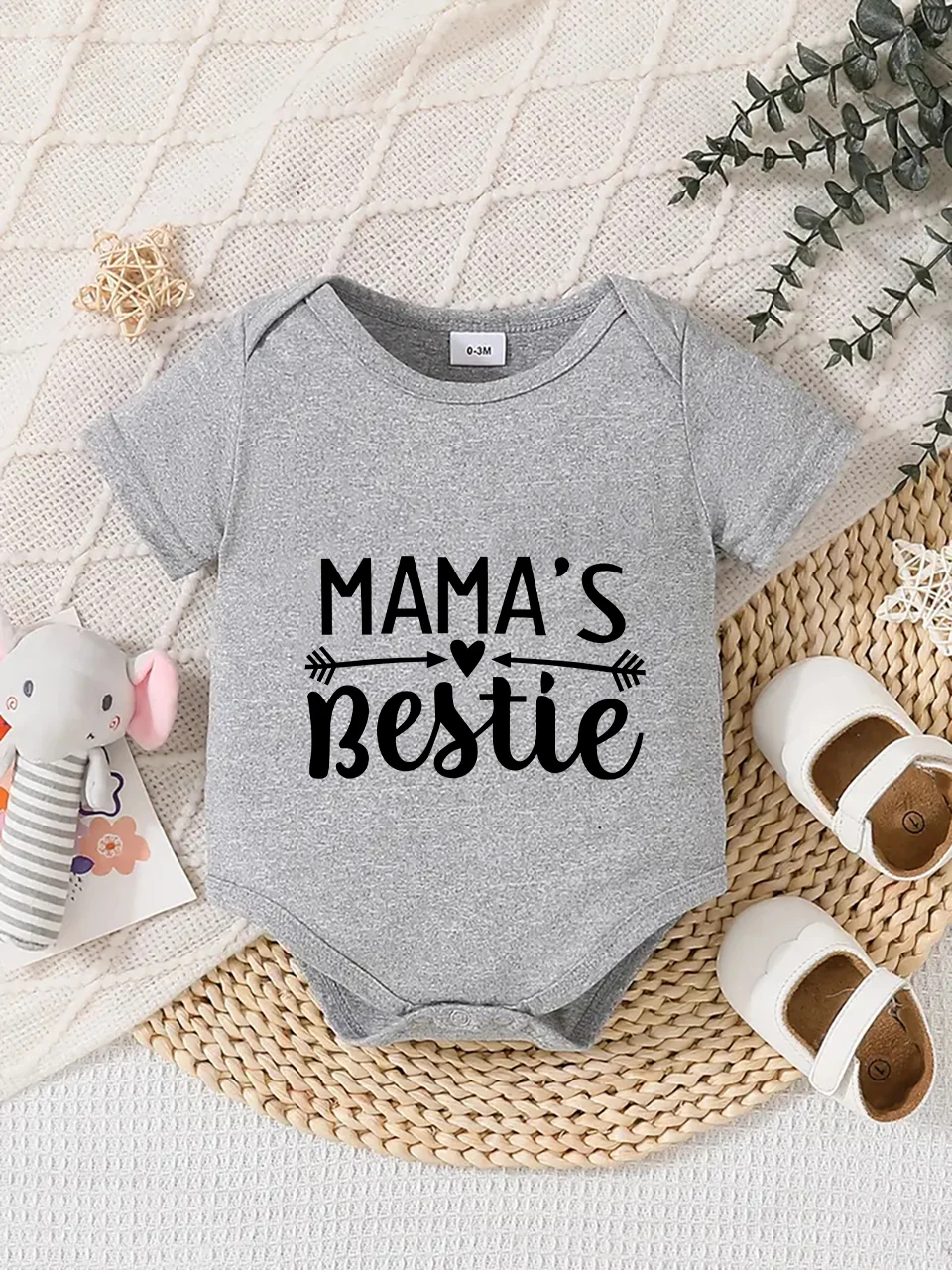Playful letter-printed baby short-sleeve triangle bodysuit. Button closure for easy dressing, machine washable