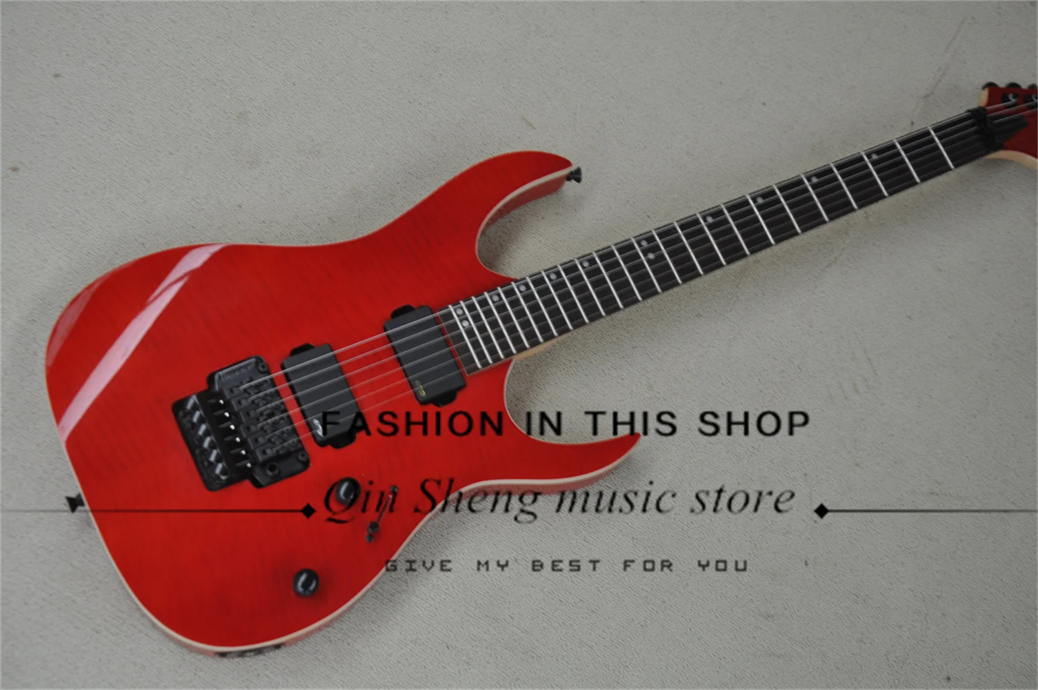 Red electric guitar, Flame maple top, white binding, tremolo bridge, rosewood fingerboard, maple neck, black hardware