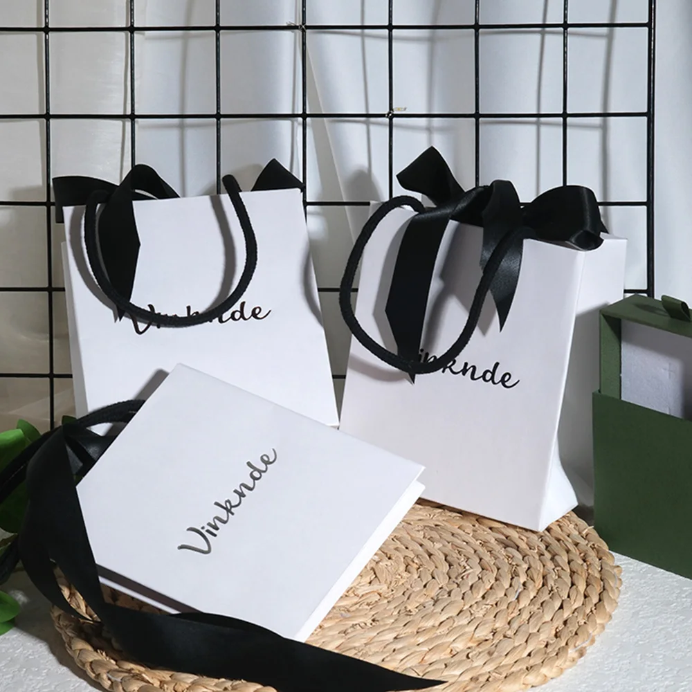 

Custom Logo Luxury Gift Paper Bag Jewelry White Cardboard Shopping Tote Bags With Bow Ribbon for Clothing Shoes Perfume Candle