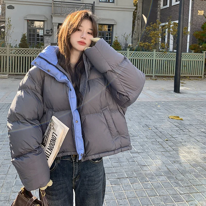 Kurtka puchowa damska z kapturem, blokowana kolorystycznie, zimowa 2025, nowa koreańska wersja, luźny krój, gruba i ciepła, uniwersalna kurtka typu chleb.