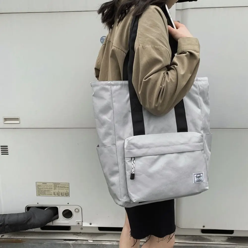 กระเป๋าสะพายข้างกันน้ำสำหรับผู้ชาย กระเป๋าถือลำลองความจุขนาดใหญ่สำหรับผู้หญิง กระเป๋าโท้ทสำหรับเดินทางไปทำงาน กระเป๋าถือผู้หญิงเรียบง่ายสำหรับการเดินทางท่องเที่ยวกลางแจ้ง