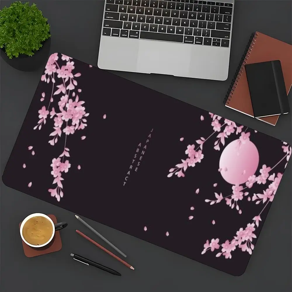 Pink cherry on a black background and a full moon suitable for work and gaming and office mouse pad