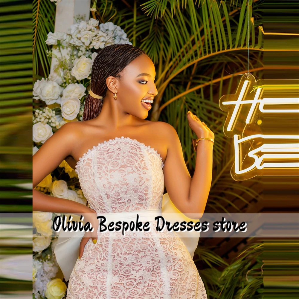 ที่โดดเด่นชุดแต่งงานลูกไม้สีขาวโบว์ลูกปัดไข่มุกที่ไม่มีสายหนัง Aso Ebi Grace ชุดสําหรับเจ้าสาวชุดราตรีชุดที่กําหนดเอง