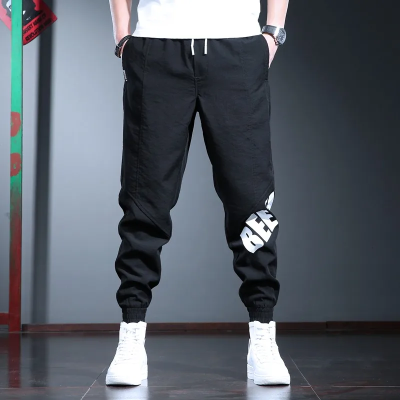 Pantalones deportivos informales para hombre, ropa de calle a la moda, con letras impresas, para correr, color negro, holgados, con cordón
