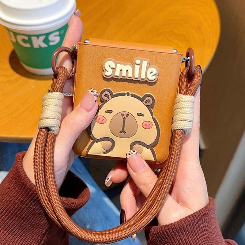 

Fashion Cartoon Smile Capibara Leather Case For Samsung Galaxy Z Flip 7 6 5 4 3 5G Hinge Full Coverage Hand Strap Bracelet Cover