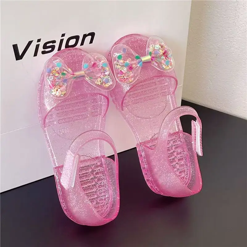 

Детские сандалии Baotou с бантом и плоской подошвой, летние новые сандалии для девочек с мягкой подошвой, нескользящие, для пляжа и улицы, сандалии для принцесс.