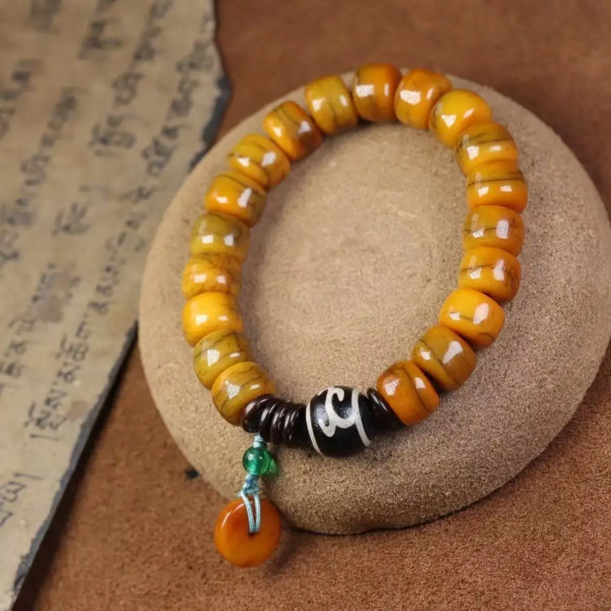 Tibetan-style camel bone barrel beads bracelet with single-loop Ruyi Dzi bead accessory