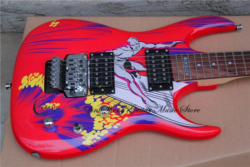 Red guitar, tremolo bridge, HH pickups, solid wood body, surf pattern, maple neck, signature on the fretboard