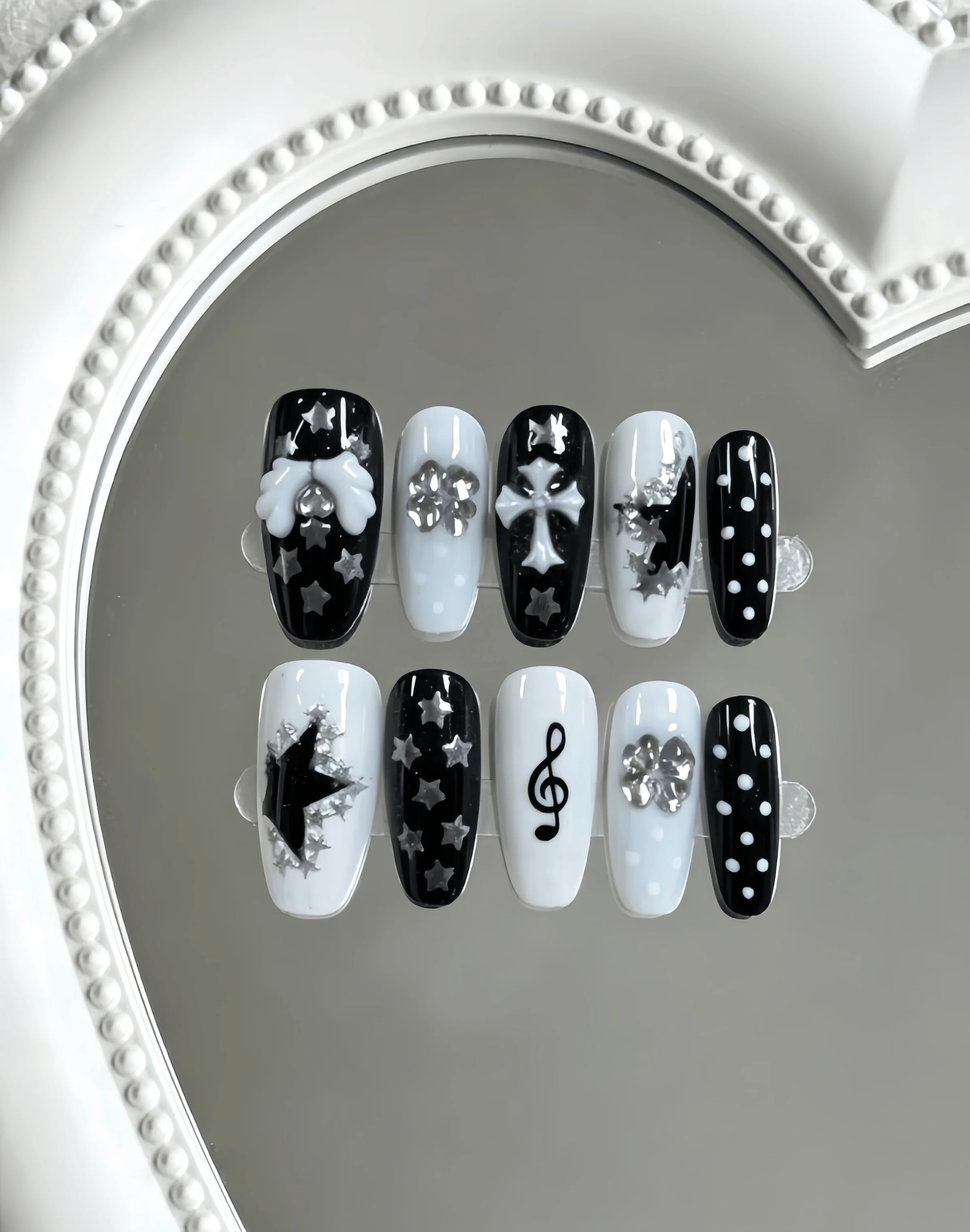 10 Medium-Length Coffin-Shaped Press-On Nails, Black and White Color Scheme with Hand-Painted Stars, Polka Dots, 3D Bows, Crosses, Musical Notes, and Rhinestone Decorations, Y2K Sweet-Cool Style, Perfect for Girls, Unique Outfits, and Energetic Occasions, Comes with Jelly Glue and Nail File