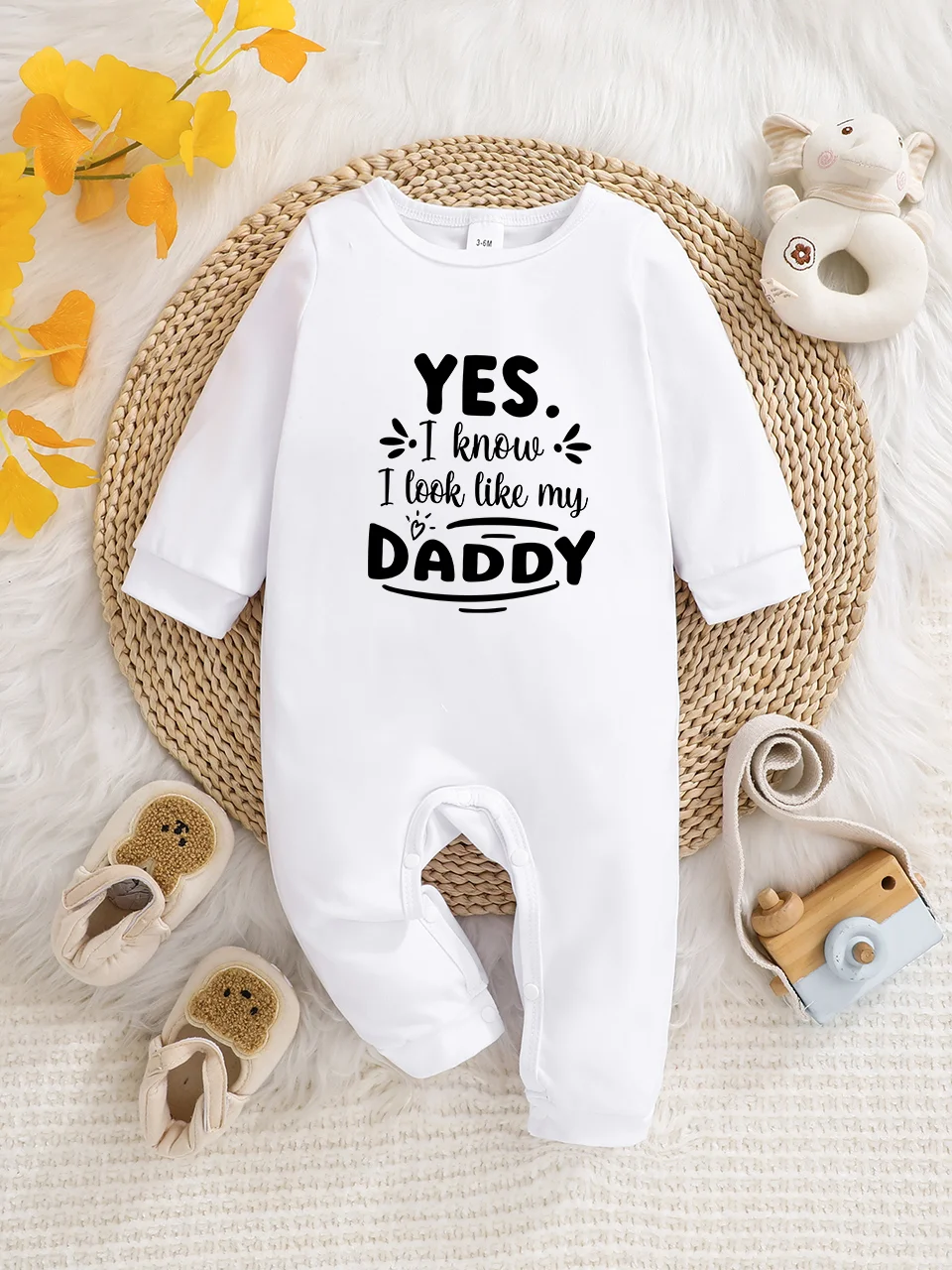 A baby long-sleeved onesie with interesting letter prints. It features a buttoned design for easy putting on and taking off, and