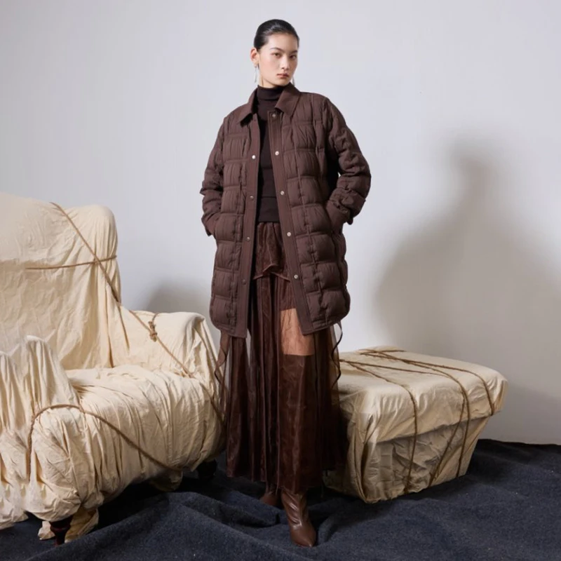 Un piumino da donna di media lunghezza di un marchio internazionale con colletto POLO, con coste corte e sottili per il calore invernale